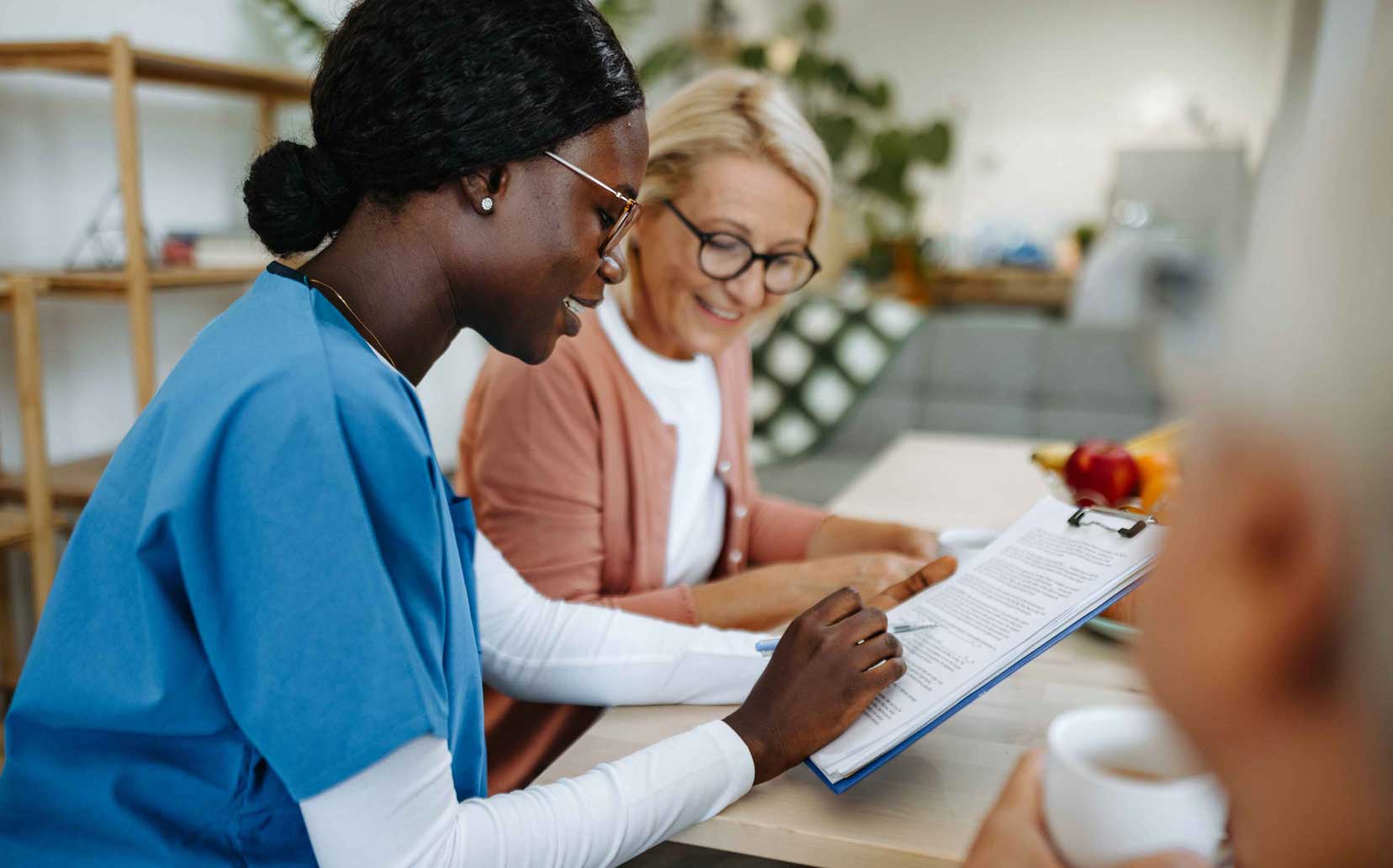 Female nurse reviewing paperwork with an woman